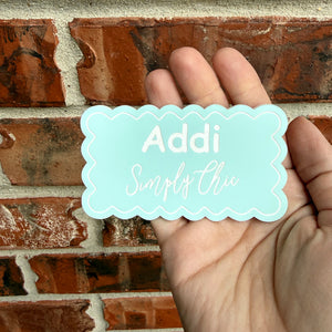 Engraved acrylic name badge held in hand
