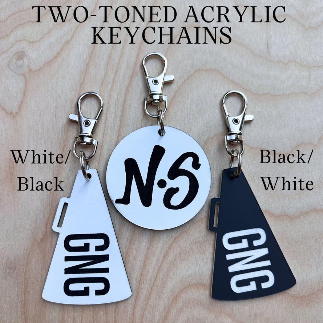 Two-toned acrylic keychains: white/black NS and black/white GNG