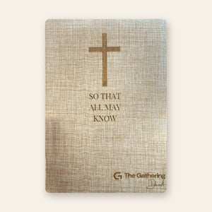 Front cover of a natural linen journal laser engraved with a cross, a verse and a church logo