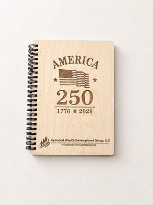 Top view of a laser engraved wood-cover spiral notebook with a black spiral and a company logo