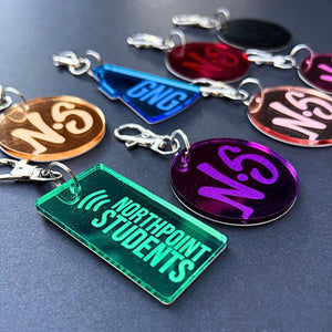 Assorted custom acrylic keychains with school and team logos