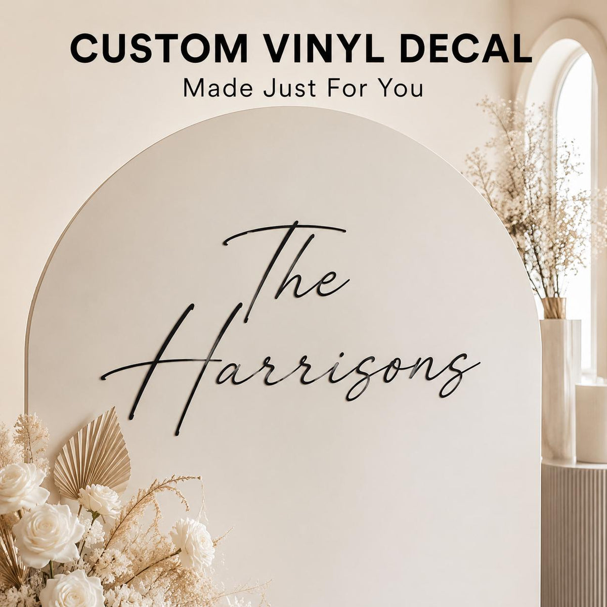 Custom vinyl decal reading The Harrisons on a white arch backdrop with florals