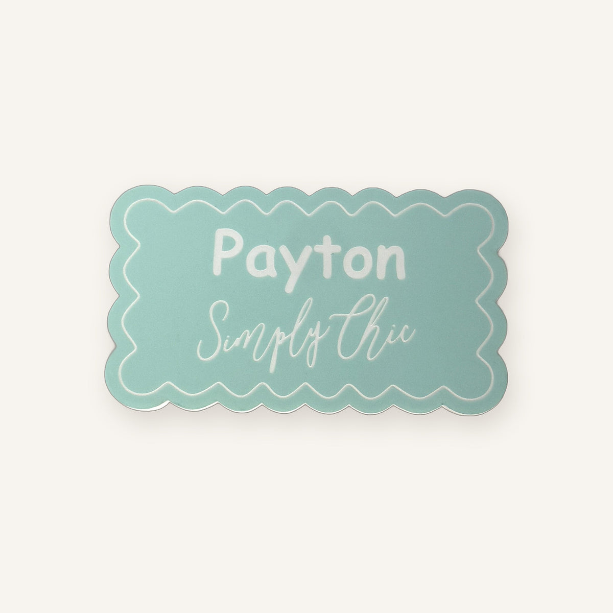 Mint scalloped engraved acrylic name badge on a clean background