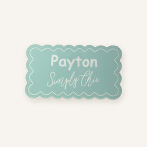 Mint scalloped engraved acrylic name badge on a clean background